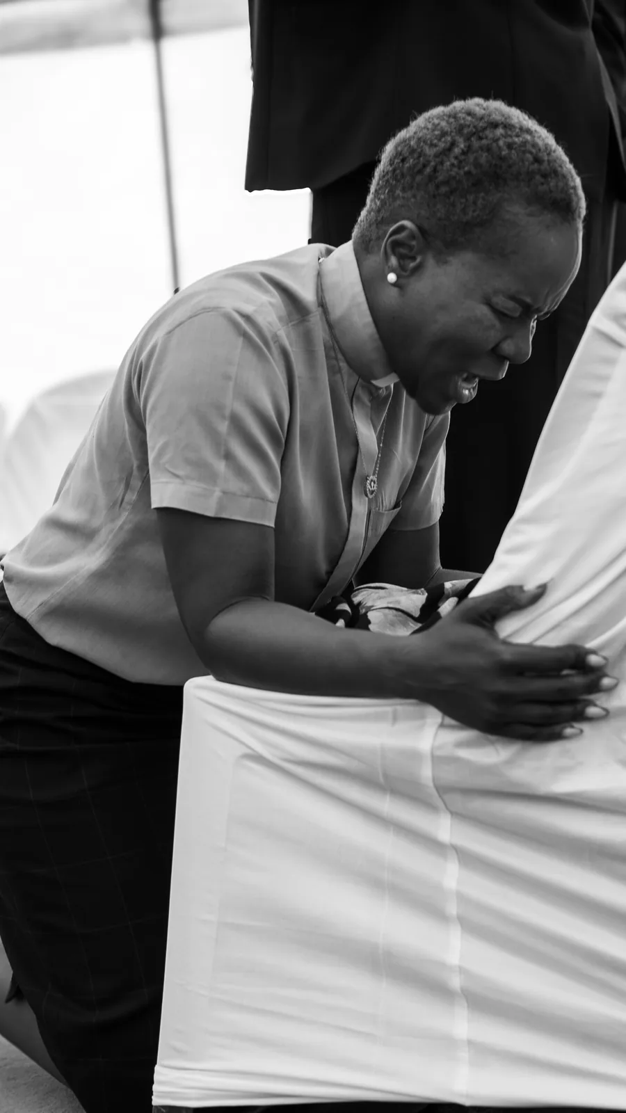 A church member kneeling in prayer