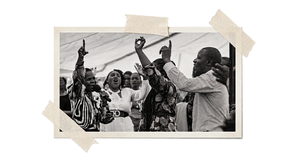 A black-and-white photograph of church members worshipping, framed with cream paper and tape