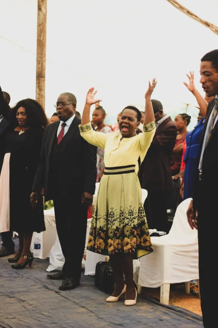 Members of Throne Room Church lifting their hands in worship